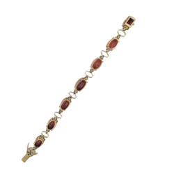 Bracelet articulé en or jaune, platine, grenats et diamants