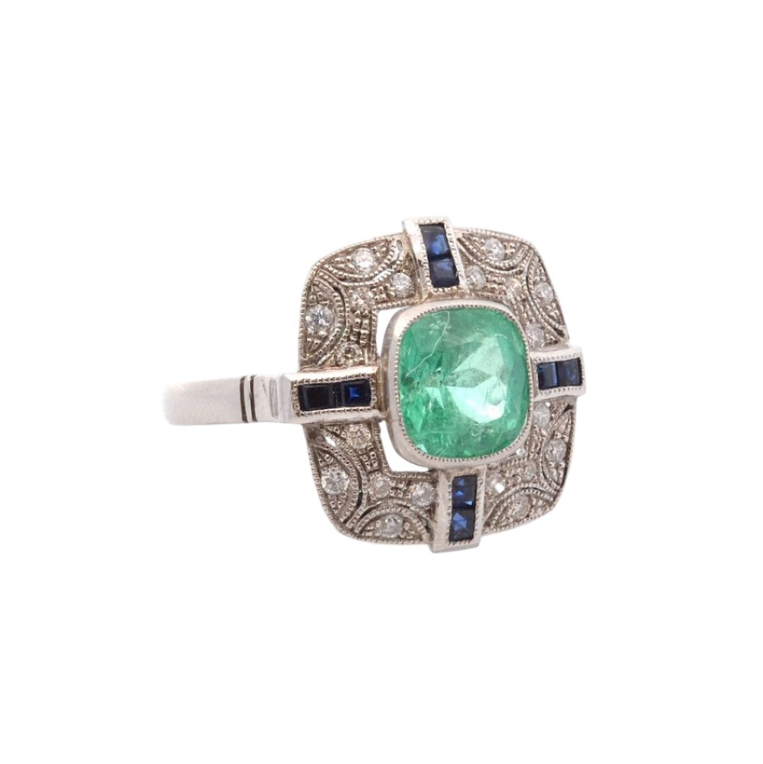 Bague Entourage en platine, émeraude, diamants, et saphirs - Castafiore