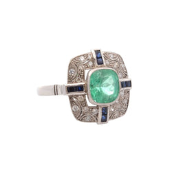 Bague Entourage en platine, émeraude, diamants, et saphirs - Castafiore