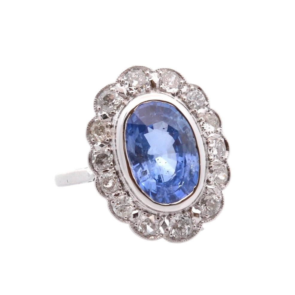 Bague Marguerite en platine, or jaune, saphir, et diamants - Castafiore