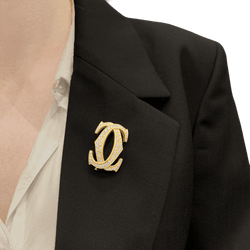 Broche CARTIER "Double C" en or jaune et diamants - Castafiore