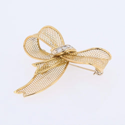 Broche noeud en or jaune et diamants - Castafiore