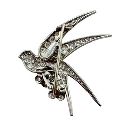 Broche "Oiseau posé sur deux fleurs" en or blanc, platine et rubis - Castafiore