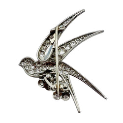 Broche "Oiseau posé sur deux fleurs" en or blanc, platine et rubis - Castafiore