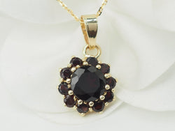 Collier pendentif marguerite en or jaune et grenats - Castafiore