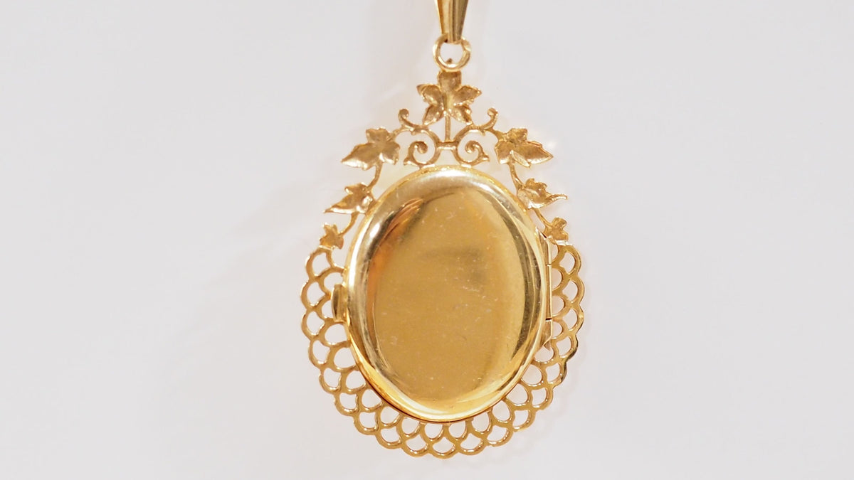 Pendentif porte photo en or jaune et émeraude