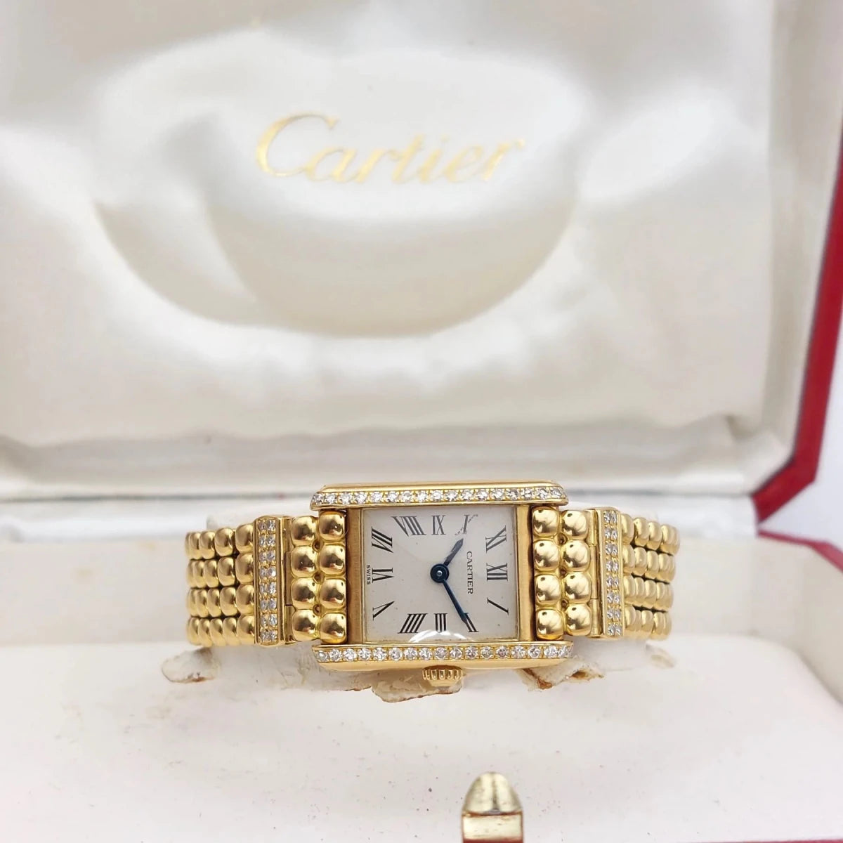 Montre CARTIER "Tank Louis Cartier Mini" en or jaune et diamants - Castafiore