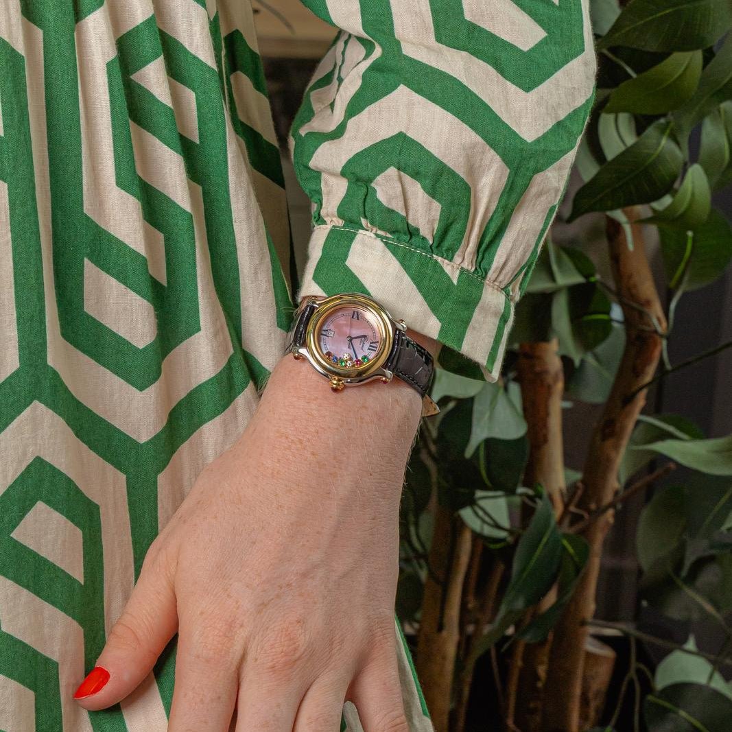 Montre CHOPARD "Happy Sport" en or jaune, acier, nacre, cuir, rubis, émeraudes, saphir et diamants - Castafiore