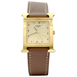 Montre HERMÈS "Heure H" en plaqué or, acier et cuir - Castafiore
