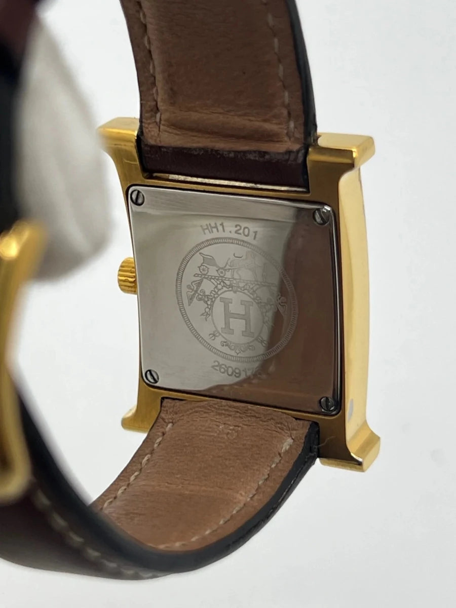 Montre HERMÈS "Heure H" plaqué or, acier et cuir - Castafiore