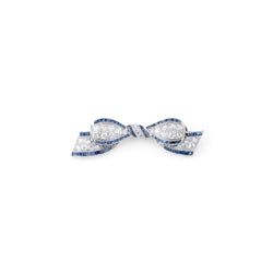 Broche nœud en platine Art Déco en diamant et saphirs calibrés - Castafiore